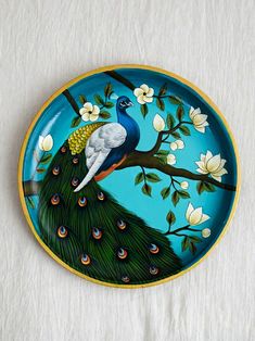 a plate with a peacock painted on it