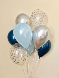 a vase filled with blue and silver balloons