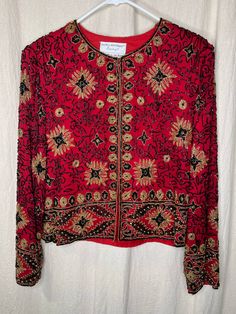 This beaded jacket is in great condition with no stains, tears, or holes. If you have any questions please feel free to ask. Flat Lay Measurements: Chest: 21 inches Shoulder: 16 inches Length: 22 inches Holiday Embellished Long Sleeve Outerwear, Vintage Embellished Festive Outerwear, Festive Embellished Vintage Outerwear, Festive Vintage Embellished Outerwear, Beaded Fall Festive Outerwear, Festive Beaded Fall Outerwear, Vintage Embellished Outerwear For Festive Occasions, Festive Beaded Outerwear, Vintage Beaded Long Sleeve Outerwear