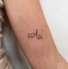 a couple of hearts tattoo on the arm