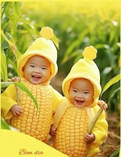 two babies dressed in corn on the cob are smiling at each other while standing next to each other