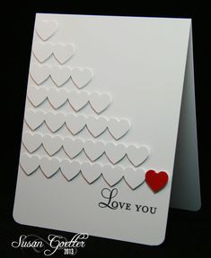 a white card with hearts on it and the words love you