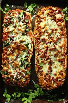 two slices of pizza on a baking sheet covered in cheese and vegetables, with parsley