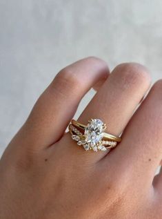 a person's hand with a ring on it and a diamond in the middle