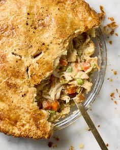 a close up of a pie on a plate with a fork in it and a piece missing