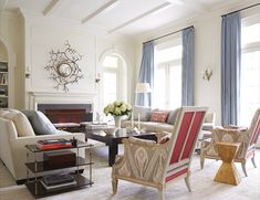 a living room filled with furniture and a fire place in the middle of a room