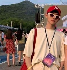 two young men standing next to each other in front of a group of people wearing sunglasses