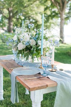 a wooden table topped with blue and white flowers