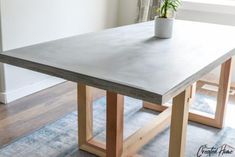 a wooden table with a potted plant on top