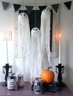 halloween decorations with candles and fake ghost heads