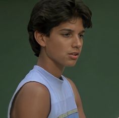 a young man holding a tennis racquet on a court