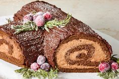 a chocolate cake with frosting and berries on top