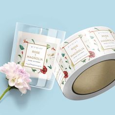 two rolls of rose and mahonia waxing tape next to a single flower