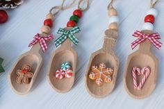 wooden spoons decorated with christmas decorations and candy canes