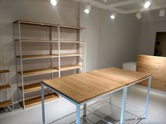 an empty room with shelves and tables in it