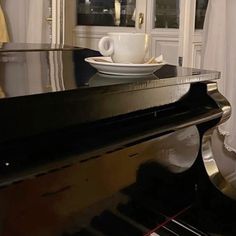 a black piano with a white plate on it