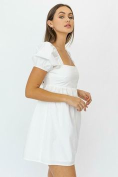 Take the Rosemary White Square Neck Puff Sleeve Babydoll Dress to your next getaway! Lightweight woven cotton shapes a square neckline, a fitted bodice, and short puffy sleeves with elastic at the shoulders and cuffs. High, loosely-fitted waistband tops the flowy babydoll mini skirt. Cutout back with dual ties finishes the look. DETAILS & CARE Cotton. Machine wash cold. Imported. White Grad Dresses, Puff Sleeve Babydoll Dress, White Babydoll Dress, White Babydoll, Summer Day Dresses, Puff Dress, Babydoll Style, White Short Dress, Grad Dresses