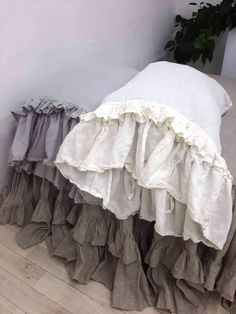 the ruffled bedspread and pillow are both made from linens that have been gathered together