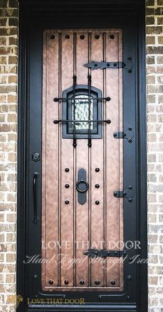 the front door to a brick building with wrought iron bars and an arched glass window