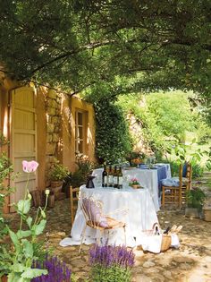 an outdoor dining area with table and chairs