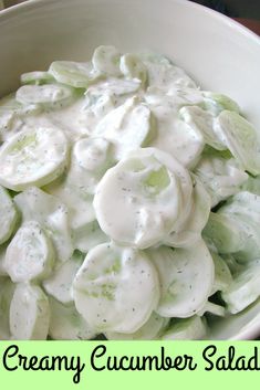 a white bowl filled with cucumber salad on top of a table