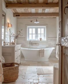 a large white bath tub sitting inside of a bathroom