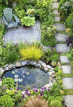 a small garden with a pond and chairs in the center, surrounded by greenery