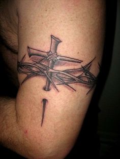 a man with a cross tattoo on his arm