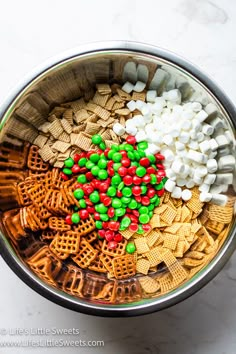 a bowl filled with cereal and marshmallows on top of a marble counter