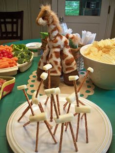 a giraffe made out of marshmallows and sticks on a table