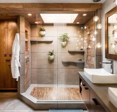 a bathroom with a shower, sink and mirror on the wall next to each other