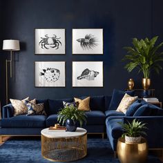 a living room with blue couches and gold accents on the walls, plants in vases