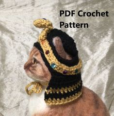 a cat wearing a crochet hat and scarf on top of it's head