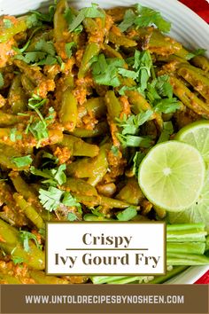 a white bowl filled with green beans and topped with cilantro, lime wedges