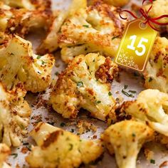 a bunch of roasted cauliflower with a red ribbon around it and the number fifteen