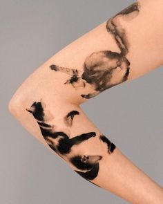 a woman's leg with black and white ink on it