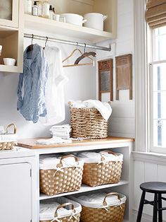 a laundry room with white walls and open shelving