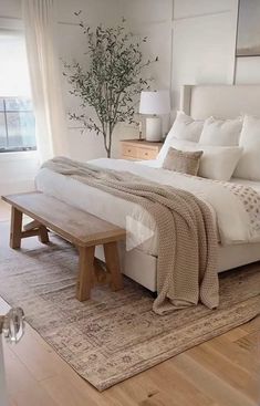 a large bed sitting on top of a wooden floor