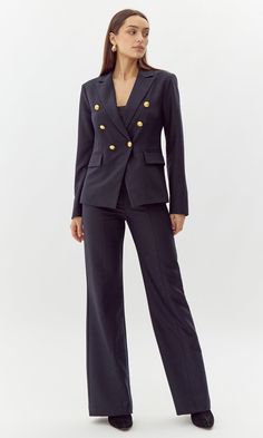 This bold blazer is adorned with gold buttons on the bodice and sleeves. The double-breasted structure also features faux, front pockets and a notched lapel. Can be matched with Colson Trousers. Blazer Double-Breasted Lined Length: 26" Chest: 17 1/4" Self: 77% Polyester, 16% Viscose, 7% Spandex Lining: 97% Polyester, 3% Spandex Hand wash in cold water with similar colors. Model is wearing a size small Style #: G247J1755 Business Casual Long Sleeve Double-breasted Pantsuit, Double-breasted Business Casual Fall Pantsuit, Fall Double-breasted Business Casual Pantsuit, Office Pantsuit With Double Button Closure For Fall, Chic Double-breasted Career Suit, Tailored Long Sleeve Pantsuit With Buttons, Tailored Long Sleeve Double-breasted Pantsuit, Office Blazer Dress With Double-breasted Button Fastening, Office Blazer Dress With Double-breasted Buttons