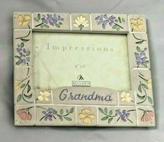 an old photo frame with flowers and the words impressionss on it's side