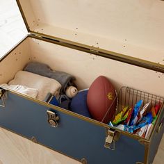 an open suitcase filled with toys on top of a hard wood floor