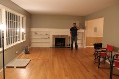 a man standing in an empty living room