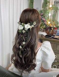 a woman with long hair and flowers in her hair