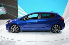 a blue car is on display at an auto show