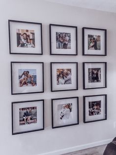 a white wall with black framed pictures on it