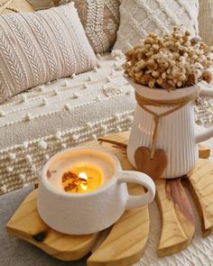 a cup of hot chocolate with marshmallows in it on a wooden tray