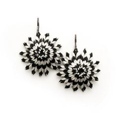 two black and white earrings on a white background