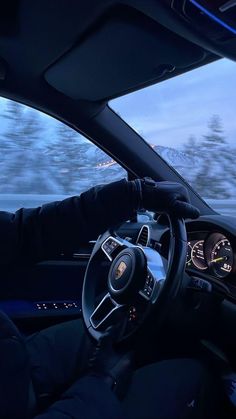 the interior of a car driving on a snowy road