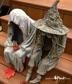 an image of a fake witch sitting on the steps with its head covered by a cloth