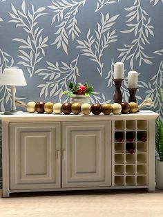 a table with some food on top of it next to a lamp and wall paper